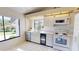 Kitchen features white cabinetry, window views, and modern appliances at 1712 Lake Cypress Dr # 1604, Safety Harbor, FL 34695