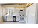White kitchen with stainless steel appliances, tile floor, and a window view at 1712 Lake Cypress Dr # 1604, Safety Harbor, FL 34695