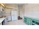 Spacious kitchen featuring white tile flooring and modern appliances, including refrigerator at 1712 Lake Cypress Dr # 1604, Safety Harbor, FL 34695