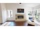 Cozy living room with fireplace, hardwood floors, and large windows offering ample natural light at 1712 Lake Cypress Dr # 1604, Safety Harbor, FL 34695