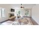 Bright living room with hardwood floors, fireplace, and sliding glass doors to a balcony at 1712 Lake Cypress Dr # 1604, Safety Harbor, FL 34695