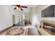 Sun-filled living room with fireplace transitions to dining area with hardwood floors and neutral paint at 1712 Lake Cypress Dr # 1604, Safety Harbor, FL 34695
