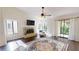 Well-lit living room with hardwood floors, fireplace, and sliding doors to a balcony at 1712 Lake Cypress Dr # 1604, Safety Harbor, FL 34695