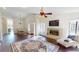 Open-concept living room with dining area features hardwood floors, fireplace, and views of the entry at 1712 Lake Cypress Dr # 1604, Safety Harbor, FL 34695