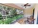 Outdoor patio showcasing patio furniture and a ceiling fan, with a view of the lush green lawn at 1712 Lake Cypress Dr # 1604, Safety Harbor, FL 34695
