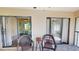 Outdoor patio with patio furniture and sliding glass doors looking into the property, with lush greenery beyond at 1712 Lake Cypress Dr # 1604, Safety Harbor, FL 34695