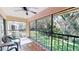 Outdoor patio showcasing lush green lawn viewed from behind black metal railings, with a ceiling fan at 1712 Lake Cypress Dr # 1604, Safety Harbor, FL 34695