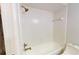 Bright white tiled shower and tub combination with bronze fixtures at 1712 Lake Cypress Dr # 1604, Safety Harbor, FL 34695