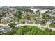 Aerial view of a community featuring mature trees and neighborhood street layout at 1717 Osprey Ln, Lutz, FL 33549
