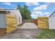 Rear view featuring access gate and partial fence at 1717 Osprey Ln, Lutz, FL 33549