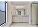 Bathroom featuring a dual sink vanity with an expansive mirror and decorative lighting at 1717 Osprey Ln, Lutz, FL 33549