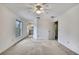 Bedroom with ceiling fan, and access to the bathroom and window at 1717 Osprey Ln, Lutz, FL 33549