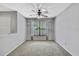 Bright bedroom with carpet, ceiling fan, a large window, and neutral-painted walls at 1717 Osprey Ln, Lutz, FL 33549
