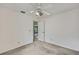 This bedroom has a ceiling fan and open door at 1717 Osprey Ln, Lutz, FL 33549