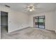 Bright bedroom with carpet, ceiling fan, and sliding glass door leading to an enclosed lanai at 1717 Osprey Ln, Lutz, FL 33549