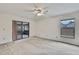 Spacious bedroom featuring a ceiling fan and sliding glass door access to the lanai at 1717 Osprey Ln, Lutz, FL 33549