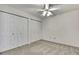 This bedroom features a ceiling fan and double door closets at 1717 Osprey Ln, Lutz, FL 33549