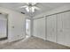 Bedroom with ceiling fan, bathroom, and closet at 1717 Osprey Ln, Lutz, FL 33549