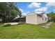 Exterior view of home showing the backyard, patio, and partial view of the home's side at 1717 Osprey Ln, Lutz, FL 33549