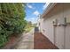 Exterior shot showing the side of the house with meticulous mulching and green bushes at 1717 Osprey Ln, Lutz, FL 33549