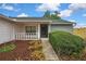 Inviting front entry with covered porch and well-kept landscaping at 1717 Osprey Ln, Lutz, FL 33549