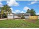 Charming single-story home featuring a well-manicured lawn, lovely landscaping, and an attached two-car garage at 1717 Osprey Ln, Lutz, FL 33549