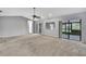 Expansive living room showcasing neutral paint, carpet, and sliding glass doors at 1717 Osprey Ln, Lutz, FL 33549