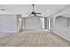 Open-plan living room with vaulted ceilings, neutral paint, carpeted flooring, and sliding glass doors at 1717 Osprey Ln, Lutz, FL 33549
