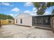 Home's rear exterior showing screened-in porch and access gate at 1717 Osprey Ln, Lutz, FL 33549