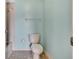 Powder blue bathroom with basic toilet and fixtures, ready for personalization at 1717 Osprey Ln, Lutz, FL 33549