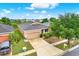 An elevated view of a well-maintained home showcasing its landscaping, driveway, and proximity to the neighborhood at 1737 Bonita Bluff Ct, Ruskin, FL 33570