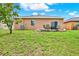 Spacious backyard with grass area, patio furniture, and a well-maintained lawn at 1737 Bonita Bluff Ct, Ruskin, FL 33570