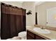 Cozy bathroom features a vanity with a sink and a toilet behind a shower curtain at 1737 Bonita Bluff Ct, Ruskin, FL 33570