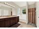 Bright bathroom with double sinks, tile floors, a large mirror, and a shower/tub combo, providing a functional layout at 1737 Bonita Bluff Ct, Ruskin, FL 33570