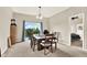 Bright dining area with a large window, carpeted floors, and a view of an adjacent bedroom at 1737 Bonita Bluff Ct, Ruskin, FL 33570