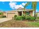 Inviting single-Gathering home featuring a two-car garage and a beautifully landscaped front yard, creating great curb appeal at 1737 Bonita Bluff Ct, Ruskin, FL 33570