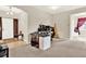 A versatile room is carpeted and includes a foyer, table and a small shelving unit against the wall at 1737 Bonita Bluff Ct, Ruskin, FL 33570