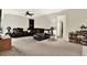 Spacious living room is carpeted with a dark leather sectional sofa and built-in bookcase providing ample storage at 1737 Bonita Bluff Ct, Ruskin, FL 33570