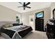 Bedroom features a ceiling fan, large windows, and a dresser with a wall-mounted TV above it at 1737 Bonita Bluff Ct, Ruskin, FL 33570