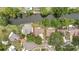 Aerial view of a neatly platted neighborhood, featuring a home with a brown roof near waterfront at 17706 Morninghigh Dr, Lutz, FL 33549