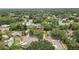 Aerial view showcasing a home nestled in a lush, tree-filled neighborhood at 17706 Morninghigh Dr, Lutz, FL 33549