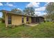 Spacious backyard featuring a screened patio, lush lawn, and mature landscaping at 17706 Morninghigh Dr, Lutz, FL 33549