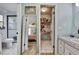 Bathroom and closet view, with sink, toilet, shower, and tile floors at 17706 Morninghigh Dr, Lutz, FL 33549