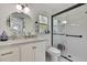 Stylish bathroom featuring a marble countertop vanity and a modern glass-enclosed shower at 17706 Morninghigh Dr, Lutz, FL 33549