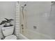 Clean white tiled shower and bath with shower curtain, potted plants, and chrome fixtures at 17706 Morninghigh Dr, Lutz, FL 33549