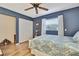Bedroom with hardwood floors, a ceiling fan, a window, and closet space at 17706 Morninghigh Dr, Lutz, FL 33549