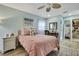 Comfortable bedroom featuring a light blue walls, ceiling fan and white night stand at 17706 Morninghigh Dr, Lutz, FL 33549