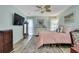 Inviting bedroom with a TV, dresser, windows, and overhead fan at 17706 Morninghigh Dr, Lutz, FL 33549