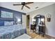 Bedroom featuring hardwood floors, a ceiling fan, and vanity table with mirror at 17706 Morninghigh Dr, Lutz, FL 33549