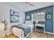 Cozy bedroom with a painting, seaside decor and a ceiling fan at 17706 Morninghigh Dr, Lutz, FL 33549